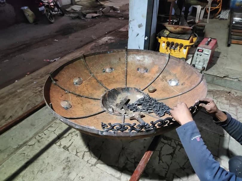 Decorative steel piece being finished in the workshop